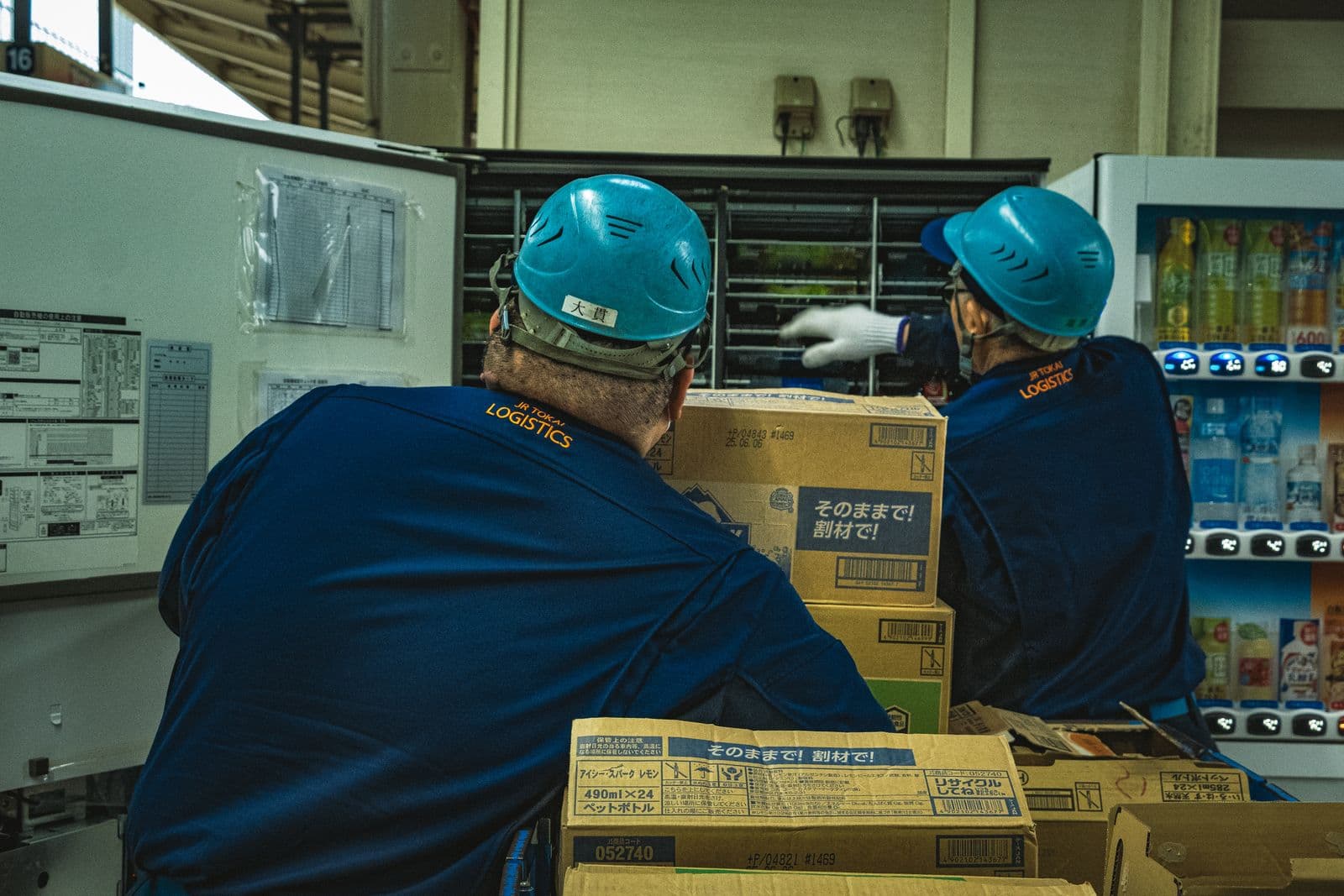 Uniformed warehouse crew handling boxes together